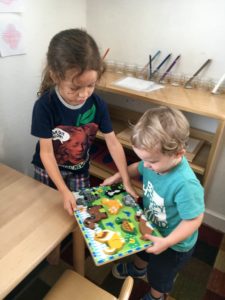 Our older student (almost 5) helps our youngest (just 2) to carry a tray. Do you think they are both happy with this arrangement?